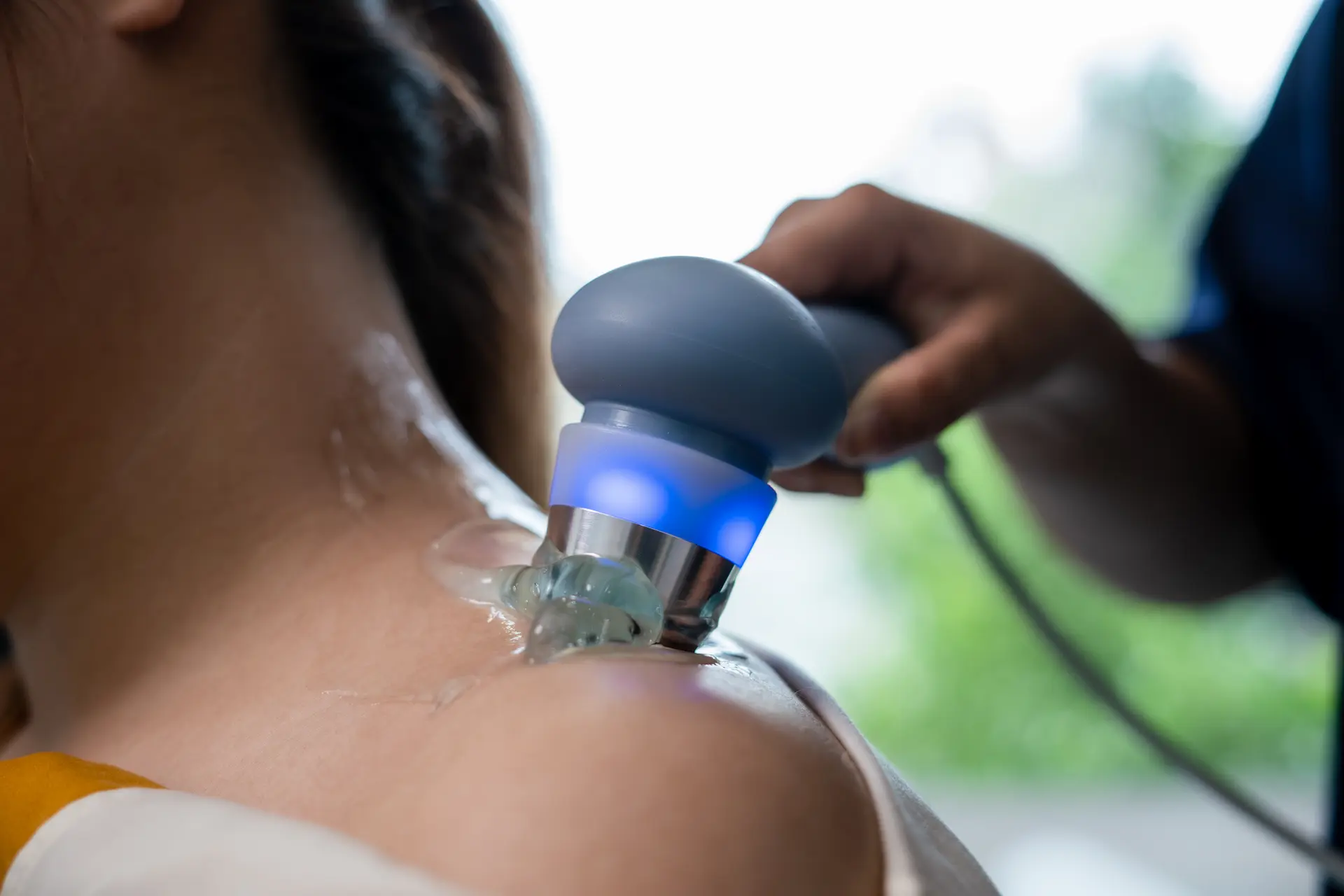 Therapeutic ultrasound being applied to soft tissue with a handheld probe